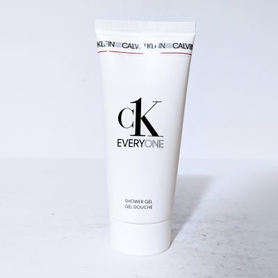 A white tube of CK Everyone shower gel stands upright on a light surface.