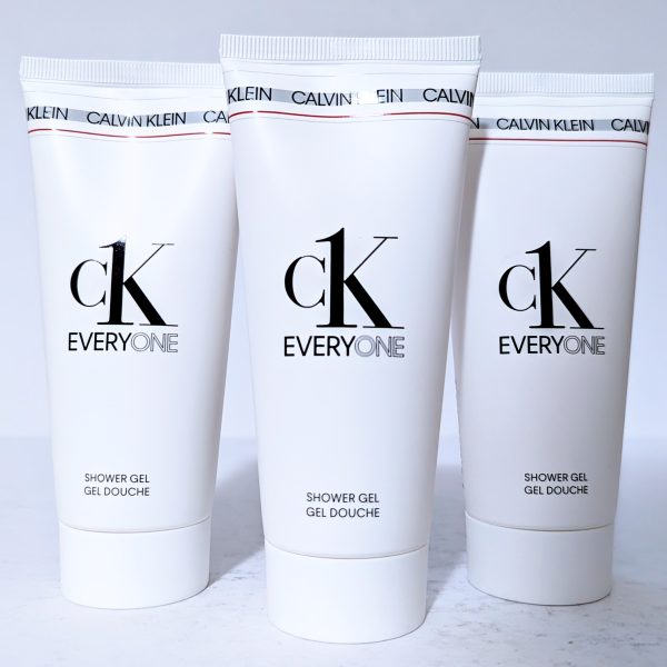 Three white tubes of Calvin Klein CK Everyone shower gel are aligned against a light background.