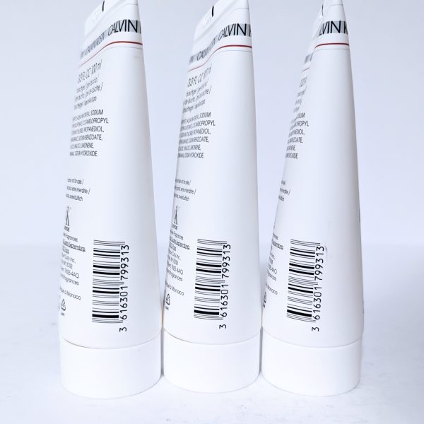 Three white cylindrical tubes with printed text and barcodes on a white background.