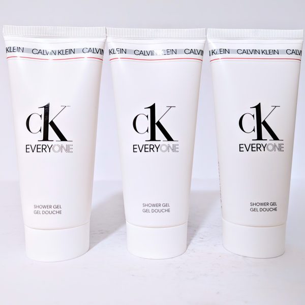 Three tubes of Calvin Klein CK Everyone shower gel, labeled in black text, are aligned on a plain surface with a white background.