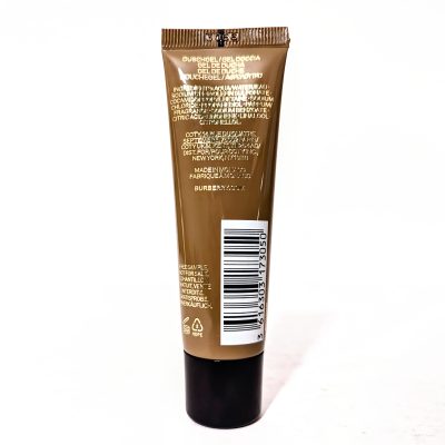 Brown tube of shower gel standing upright, with text and barcode on the side.