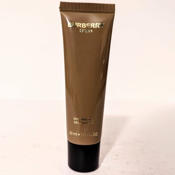 A small, brown tube of Burberry Hero shower gel. The text indicates a volume of 30 ml or 1.0 fl oz.