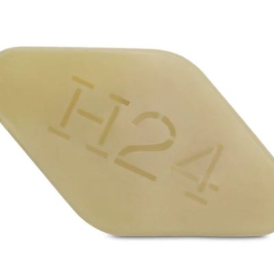 A trapezoidal beige pill imprinted with "H24" refers to the Hermès H24 Face, Body And Hair Cleansing Bar, a 100g soap for men.