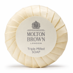 A set of three Molton Brown triple-milled milk soap round bars (25g each), wrapped in cream-colored paper with a central label featuring the brand and product name.