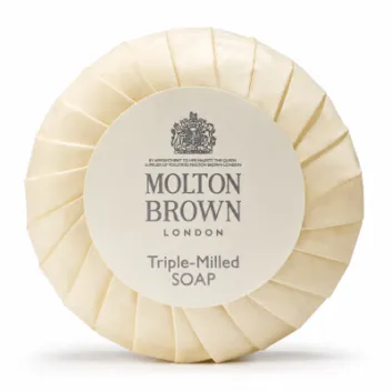 A set of three Molton Brown triple-milled milk soap round bars (25g each), wrapped in cream-colored paper with a central label featuring the brand and product name.