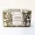 Rectangular bar of exfoliating soap in green packaging with white illustrations and label, featuring brand and origin details.