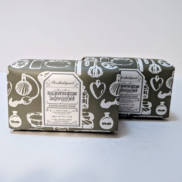 Two wrapped bars of Penhaligon's Blenheim Bouquet exfoliating soap with green packaging featuring white botanical illustrations.