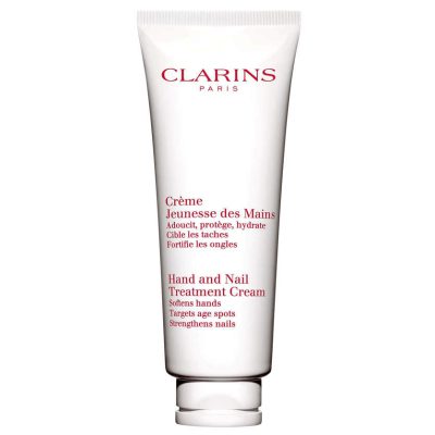 A white tube of Clarins Skincare Hand & Nail Treatment Cream 100ml, featuring red text and designed to soften hands and strengthen nails.