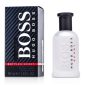 A 50ml Hugo Boss Boss Bottled Sport EDT Spray for Men is placed next to its distinctive black and red branded box.
