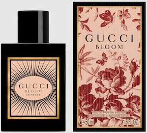 A bottle of Gucci Bloom Intense Eau de Parfum 50ml Spray for Her is displayed beside its floral-patterned box, both featuring the product name and size.