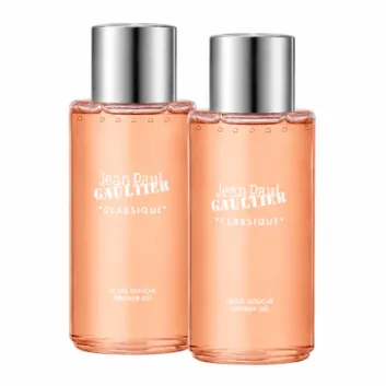 Two identical bottles of Jean Paul Gaultier Classique Bath & Shower Gel, 200ml, with silver caps and peach-colored liquid, are standing side by side against a white background.