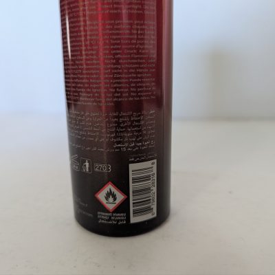 The image shows the lower part of a 2x Police Instinct Deodorant Spray for Men, 200ml can with warning symbols including flammable hazard, a barcode, and multilingual text.