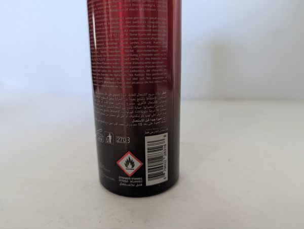 The image shows the lower part of a 2x Police Instinct Deodorant Spray for Men, 200ml can with warning symbols including flammable hazard, a barcode, and multilingual text.