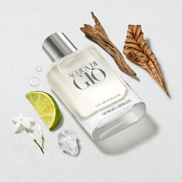 A 200ml bottle of Giorgio Armani Acqua Di Gio EDT Spray for men is pictured with a lime wedge, white flower, ice cube, water droplets, a dried brown leaf, and a piece of wood.