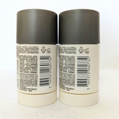 Two deodorant sticks placed side by side with ingredient lists and barcodes visible on their labels.