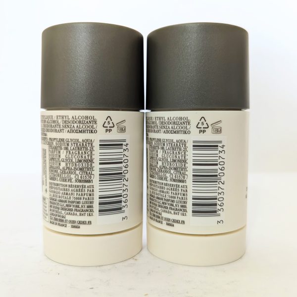 Two deodorant sticks placed side by side with ingredient lists and barcodes visible on their labels.