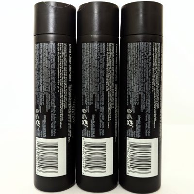 Three black shampoo bottles are shown standing upright side by side, displaying product information and barcodes on their back labels.