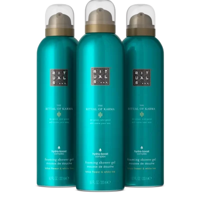 Three teal bottles of Rituals The Ritual of Karma Foaming Shower Gel 200ml are placed side by side against a plain black background.