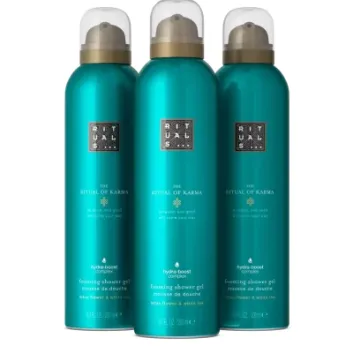 Three teal bottles of Rituals The Ritual of Karma Foaming Shower Gel 200ml are placed side by side against a plain black background.