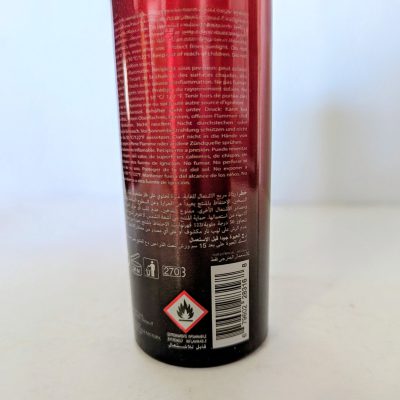 A close-up of the back of a 200ml 3x Police Instinct Deodorant Spray for Men can, displaying multilingual instructions, a barcode, hazard symbols, and a flammable warning icon.