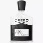 A clear glass bottle of Creed Aventus Eau de Parfum EDP 100ml Spray for Men features a black cap, black label, and an illustration of a man on horseback.