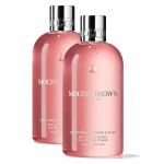 Two bottles of Molton Brown Delicious Rhubarb & Rose Bath & Shower Gel 300ml Unisex, featuring pink gel and silver caps with white text labels, are positioned side by side against a white background.
