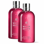 Two bottles of Molton Brown Fiery Pink Pepper Bath & Shower Gel 300ml (unisex), each featuring a silver cap and vibrant pink liquid, are displayed against a white background.