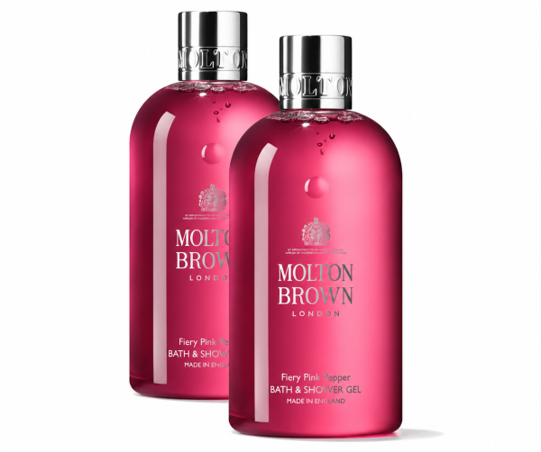 Two bottles of Molton Brown Fiery Pink Pepper Bath & Shower Gel 300ml (unisex), each featuring a silver cap and vibrant pink liquid, are displayed against a white background. Two bottles of Molton Brown Fiery Pink Pepper Bath & Shower Gel 300ml (unisex), each featuring a silver cap and vibrant pink liquid, are displayed against a white background.