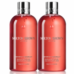 Two bottles of 2x Molton Brown Heavenly Gingerlily Bath & Shower Gel 300ml, Womens, each featuring silver caps and filled with red liquid, are arranged side by side against a white background.
