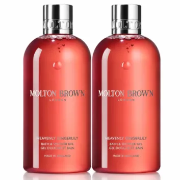 Two bottles of 2x Molton Brown Heavenly Gingerlily Bath & Shower Gel 300ml, Womens, each featuring silver caps and filled with red liquid, are arranged side by side against a white background.