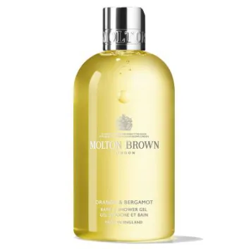 A clear yellow 300ml bottle of Molton Brown Orange & Bergamot Shower Gel (Unisex) with a silver cap and English text on the front label.