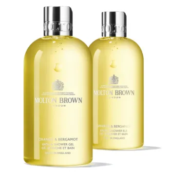 Two bottles of Molton Brown Orange & Bergamot Shower Gel 300ml, unisex, with silver caps are shown on a white background.
