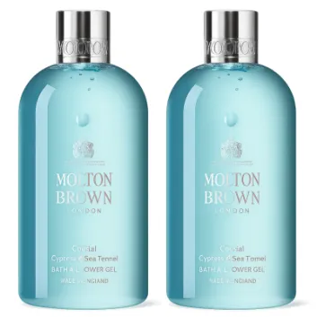 Two bottles of Molton Brown Coastal Cypress & Sea Fennel Bath and Shower Gel (300ml, unisex) with silver caps, clear blue liquid, and white labels stand side by side against a white background.