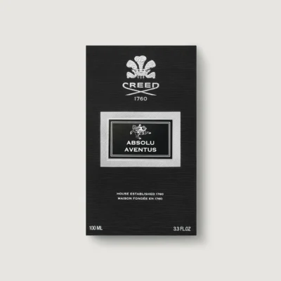 Black rectangular box of Creed Absolu Aventus fragrance with white and silver text displaying brand, product name, and size (100 ml, 3.3 fl oz) on a plain light background.