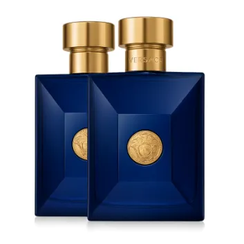 Two rectangular dark blue Versace Pour Homme Dylan Blue Deodorant Spray bottles for men, 100ml each, with gold caps and medallions, displayed against a plain white background.