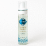 A clear bottle of 3x Fake Bake Eau de Bronzage Tanning Water Spray, 198ml, with a pump and blue label is displayed against a white background.