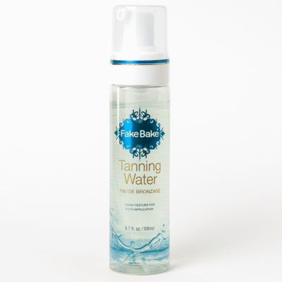 A clear bottle of 3x Fake Bake Eau de Bronzage Tanning Water Spray, 198ml, with a pump and blue label is displayed against a white background.