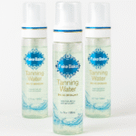 Three bottles of Fake Bake Eau de Bronzage Tanning Water Spray (198ml each) are displayed on a white background.