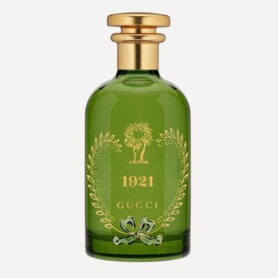 The Gucci 1921 Eau de Parfum Spray, Unisex, 100ml, comes in a green glass bottle with a gold cap, gold accents, and a tree motif on the front.