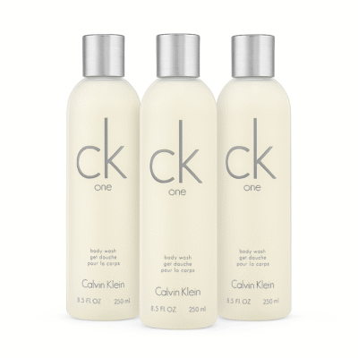 Three bottles of CK One Shower Gel Body Wash 250ml, unisex, with silver caps, are lined up side by side against a white background.
