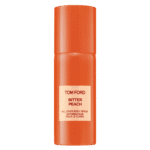 Two orange spray bottles labeled "Tom Ford Bitter Peach All Over Body Spray" stand upright against a plain white background.