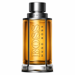 A 50ml bottle of Hugo Boss The Scent EDT for Men, featuring amber liquid inside a clear, cylindrical glass bottle with metallic cap and accents.