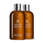 Two 300ml bottles of Molton Brown Tobacco Absolute Bath and Shower Gel are placed side by side against a white background.