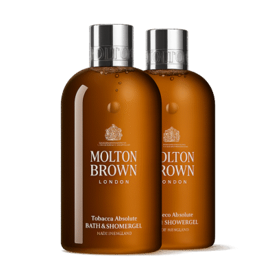 Two 300ml bottles of Molton Brown Tobacco Absolute Bath and Shower Gel are placed side by side against a white background.