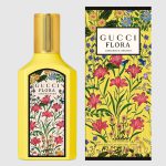 A yellow bottle of Gucci Flora Gorgeous Orchid EDP 50ml Spray for women is displayed beside its matching floral-patterned box.