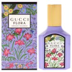 A bottle and box of Gucci Flora Gorgeous Magnolia Eau de Parfum for Women, 100ml Spray, featuring floral designs and purple packaging.
