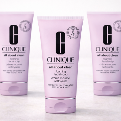 Three pink 150ml tubes of 3x Clinique Foaming Sonic Facial Soap are displayed upright on a light surface.