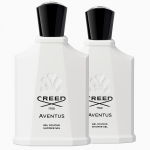 Two white bottles of Creed Aventus for Her Shower Gel 200ml with black caps are placed side by side, displaying the embossed logo and product details on the front.