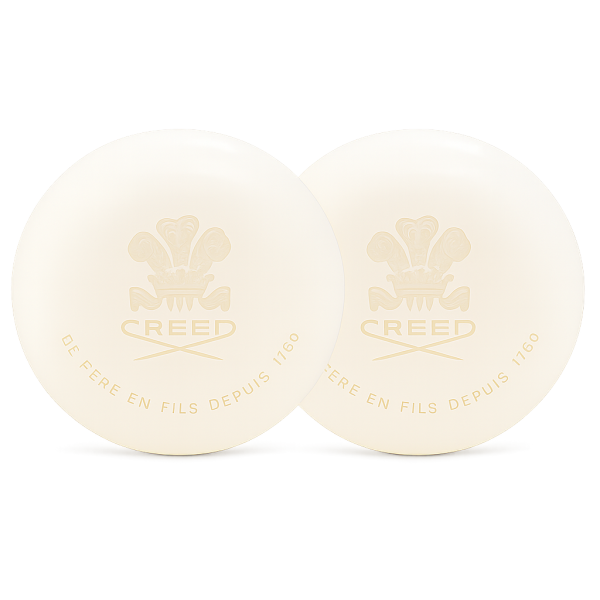 Set of two off-white Creed Aventus Millesime Bar Soaps for Men (150g each), both round and embossed with the Creed logo and "DE PÈRE EN FILS DEPUIS 1760".