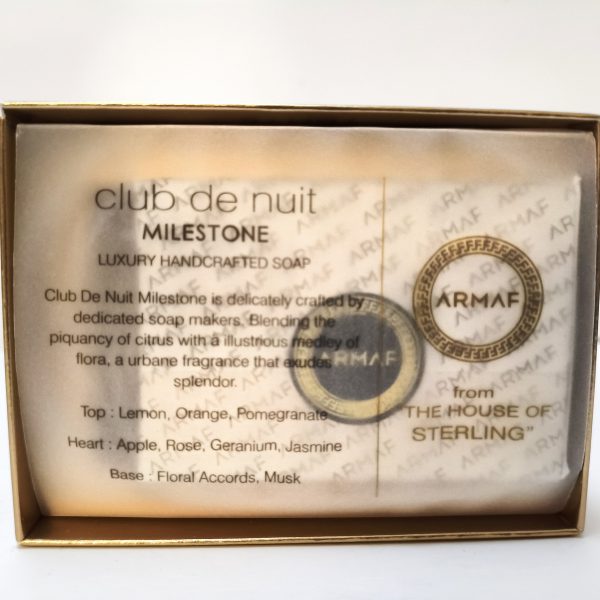 A packaged bar of Club De Nuit Milestone luxury handcrafted soap by Armaf, displaying its ingredients and fragrance notes on the label inside the box.
